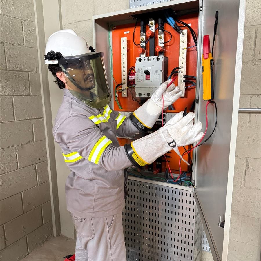 Engenheiro com vestimenta de proteção em painel elétrico
